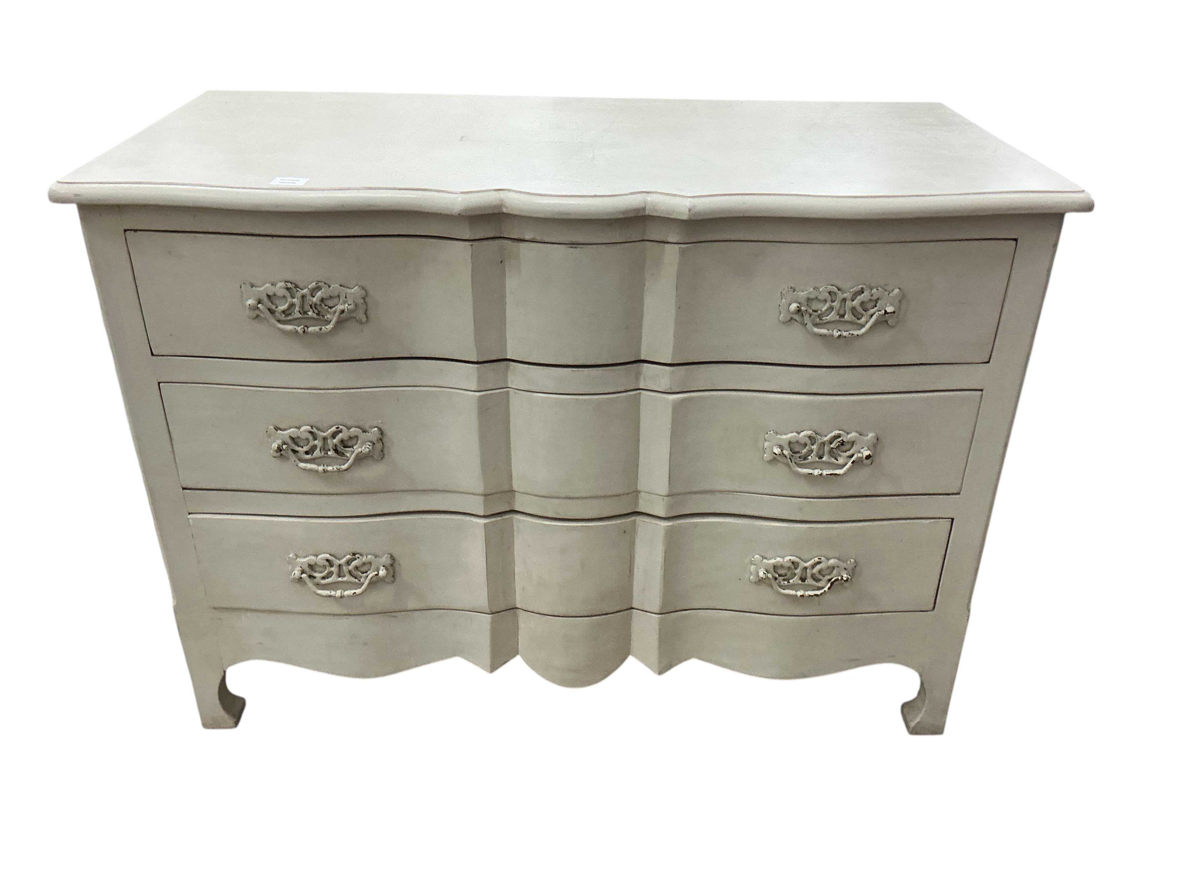 An 18th century style cream painted three drawer commode, width 126cm, depth 61cm, height 90cm, Provenance: The late Kenneth Turner (1936-2025), celebrity florist, designer and perfume retailer, he received the Royal War
